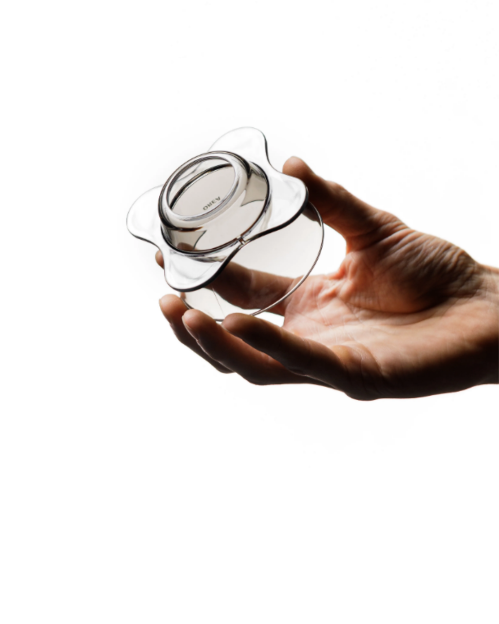 Hand holding a clear flower-shaped glass object